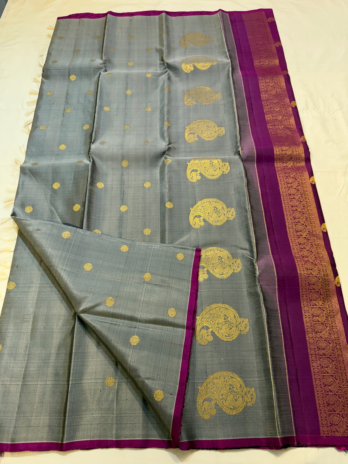 Close-up of ornate kamalam butta in gold zari on steel grey Kanjipuram silk saree — Idam Living