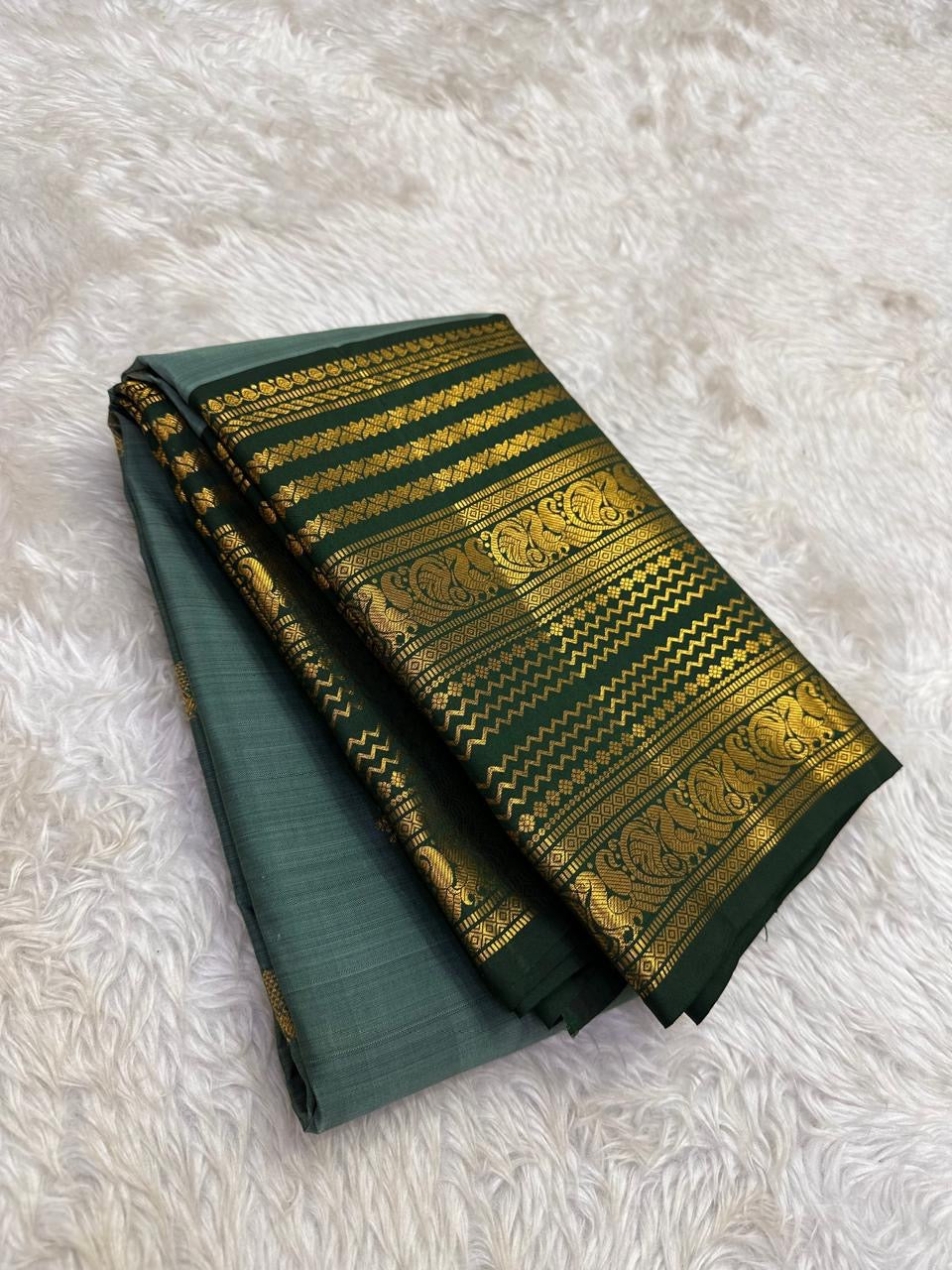 Close view of Varisaipet body showing Floral Butta in gold zari on sage green silk