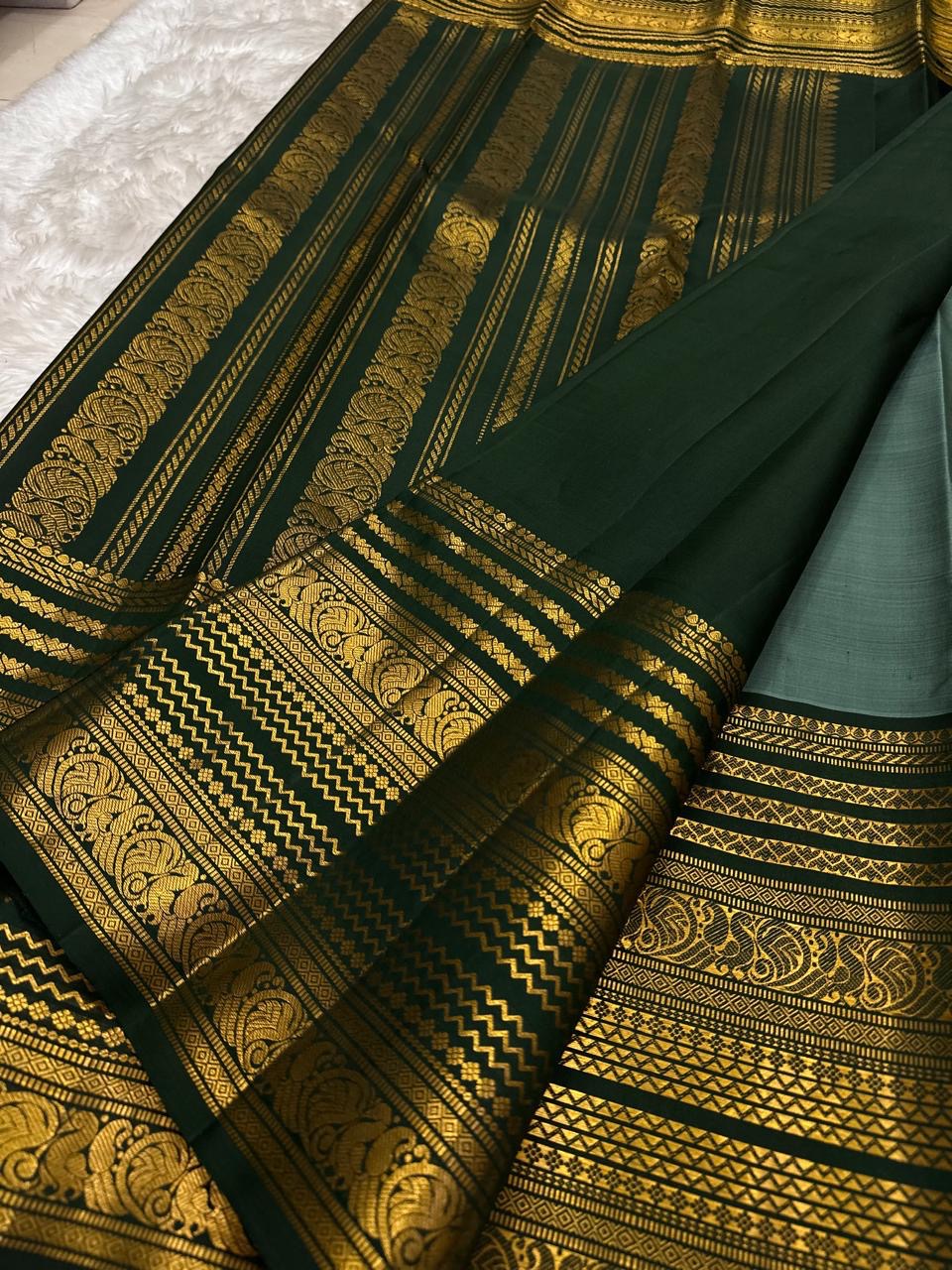 Deep forest green border with Vanasringaram Yaanai motifs in gold zari on sage green KanchiPattu
