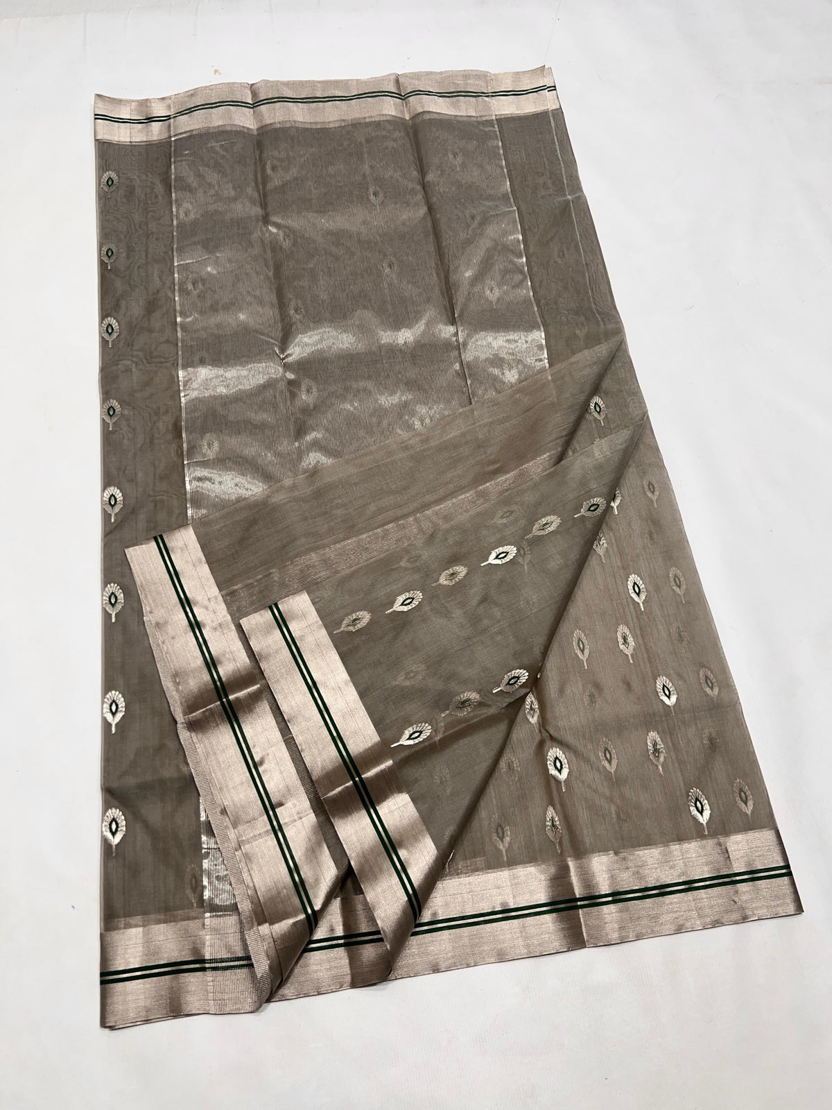 Full view of Stone Grey handloom Chanderi saree showing silver motifs and broad border with twin Emerald Green lines.
