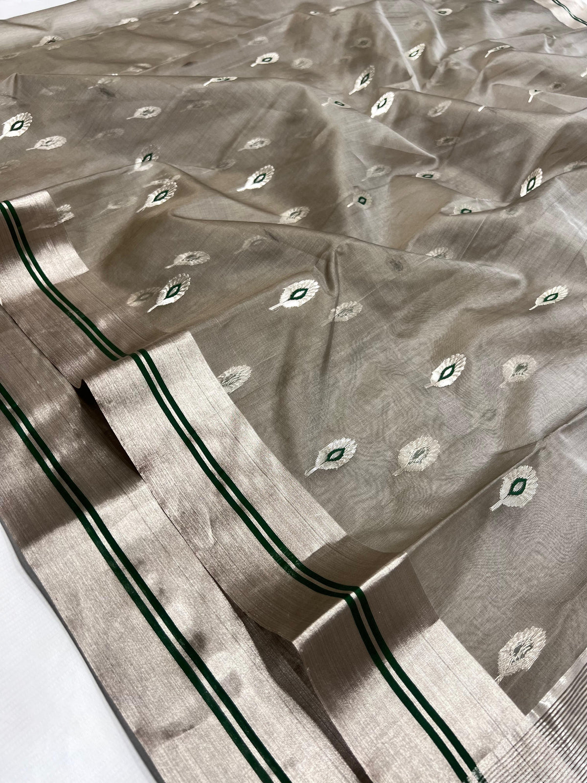 Stone Grey Katan Silk Chanderi saree showing the broad silver-tone border with twin Emerald Green lines.