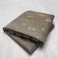 Stone Grey Katan Silk Chanderi saree with scattered silver feather motifs, emerald-green accents and broad silver border.