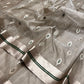 Stone Grey Katan Silk Chanderi saree border detail showing the silver-tone band with parallel Emerald Green lines.