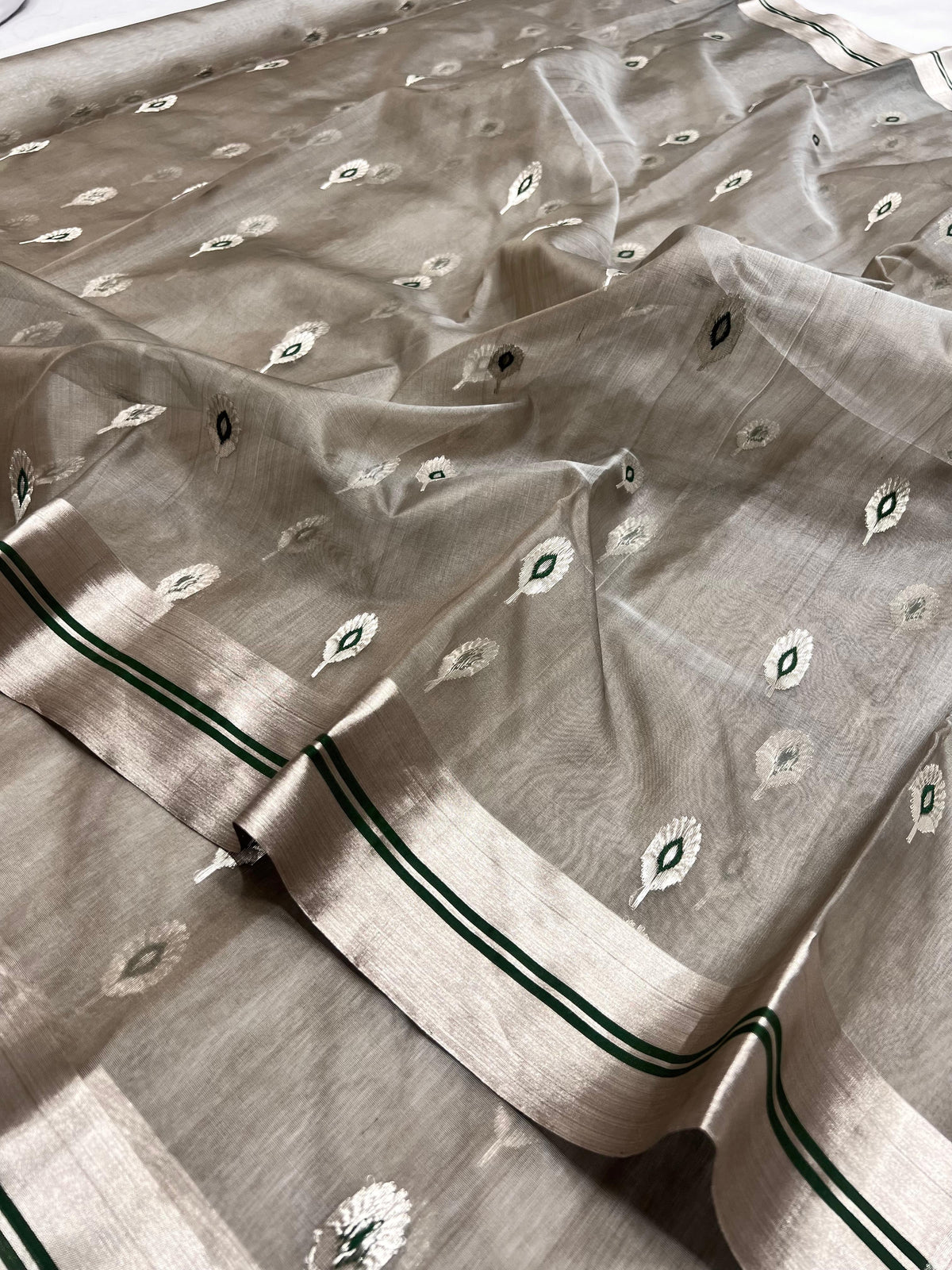 Stone Grey Katan Silk Chanderi saree border detail showing the silver-tone band with parallel Emerald Green lines.