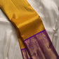 Blouse piece carrying the same broad purple border on sunflower yellow Kanjivaram saree