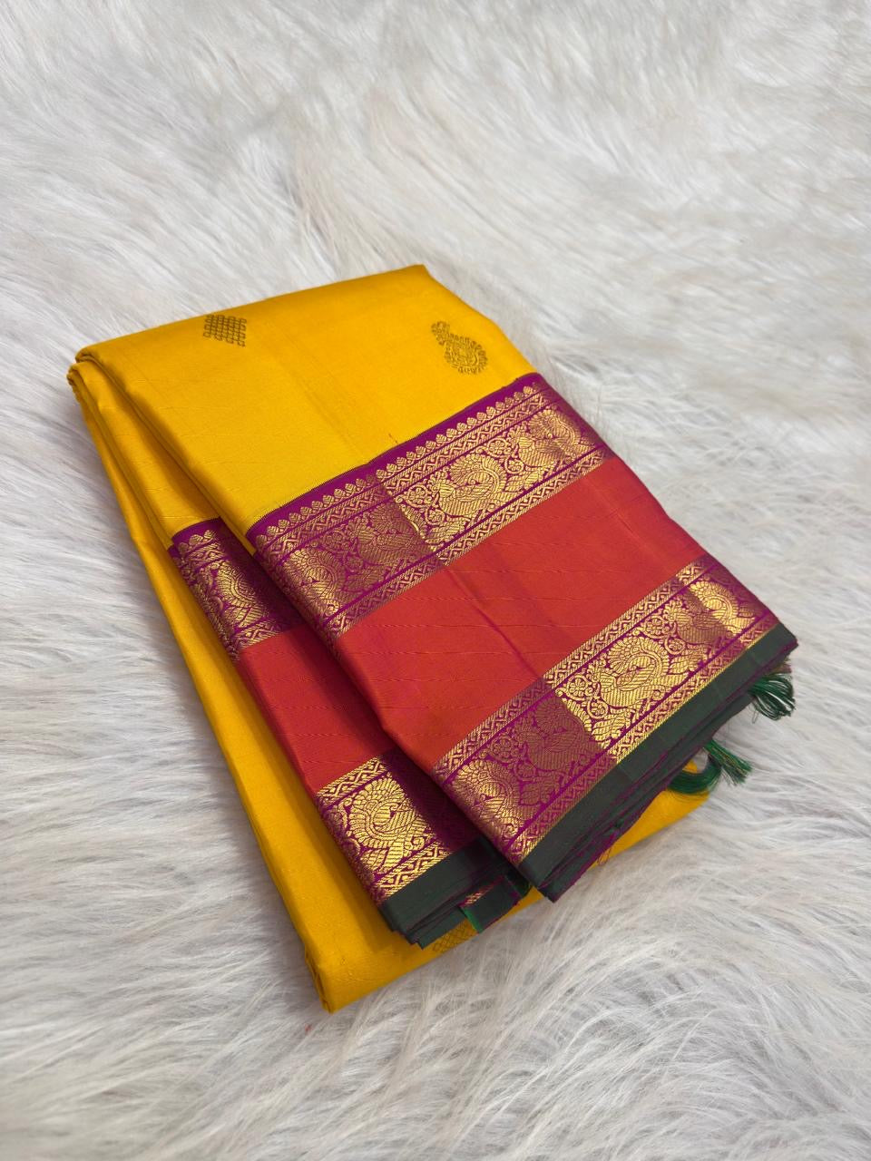 Sunflower-Manjal yellow pure silk body with evenly spaced traditional Mayil zari buttas.