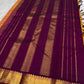 Sunset orange Kanchipuram silk saree with aubergine purple korvai border and antique gold zari