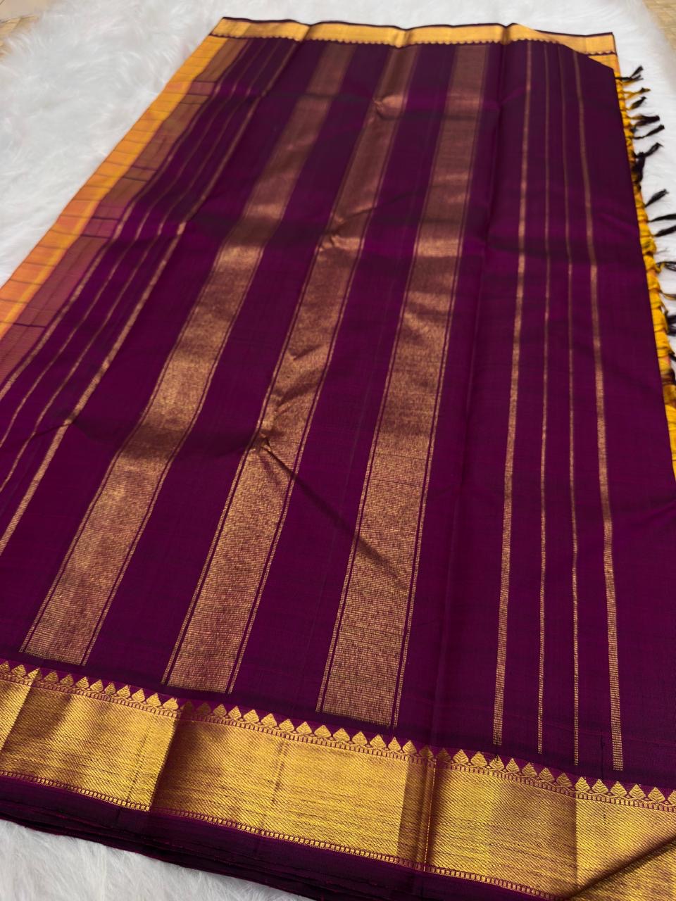 Sunset orange Kanchipuram silk saree with aubergine purple korvai border and antique gold zari