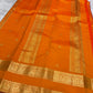 Kanchipattu silk saree in sunset orange with reddish pink border Veldhari Rettapet weave traditional zari detail