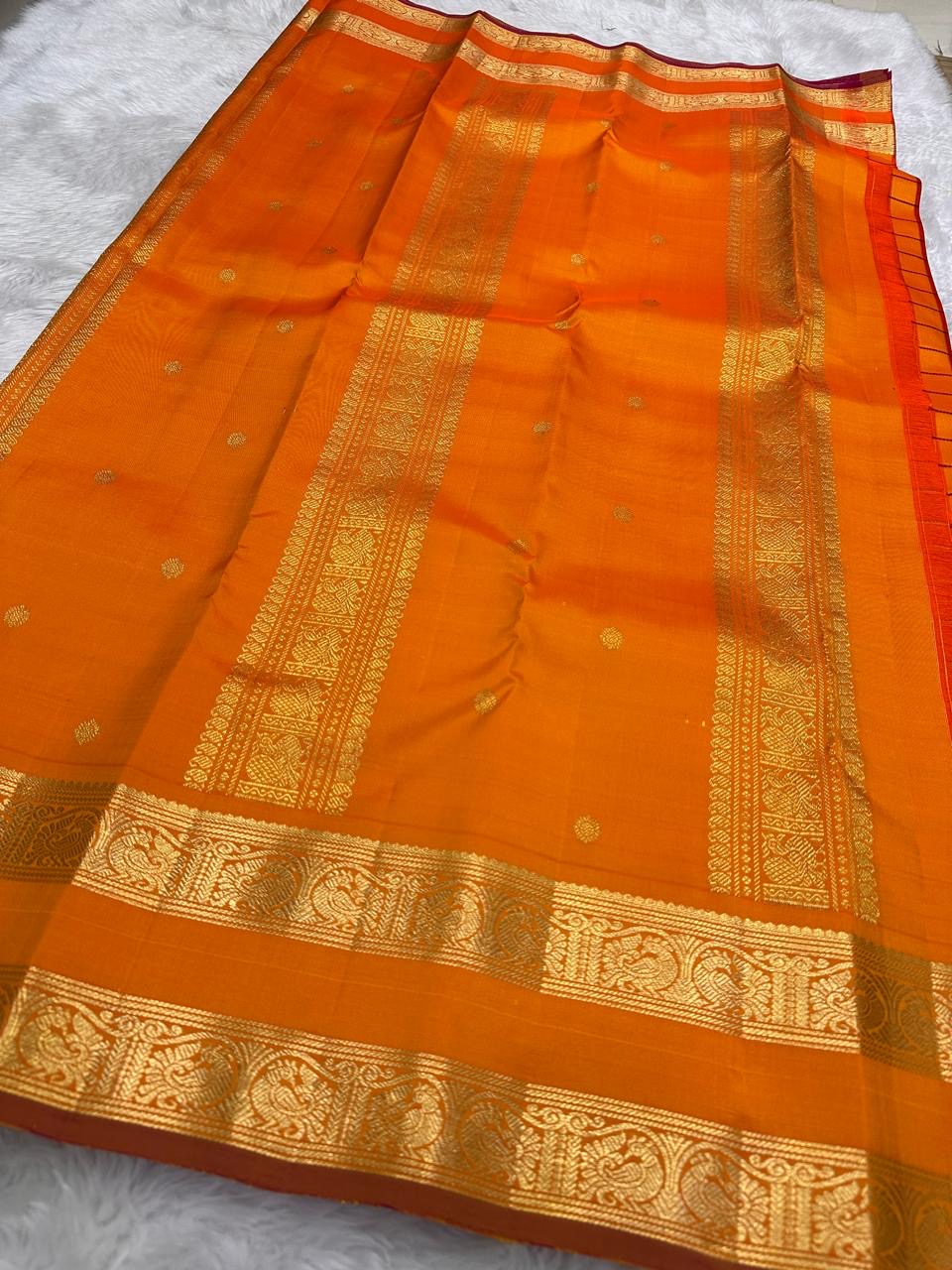 Kanchipattu silk saree in sunset orange with reddish pink border Veldhari Rettapet weave traditional zari detail