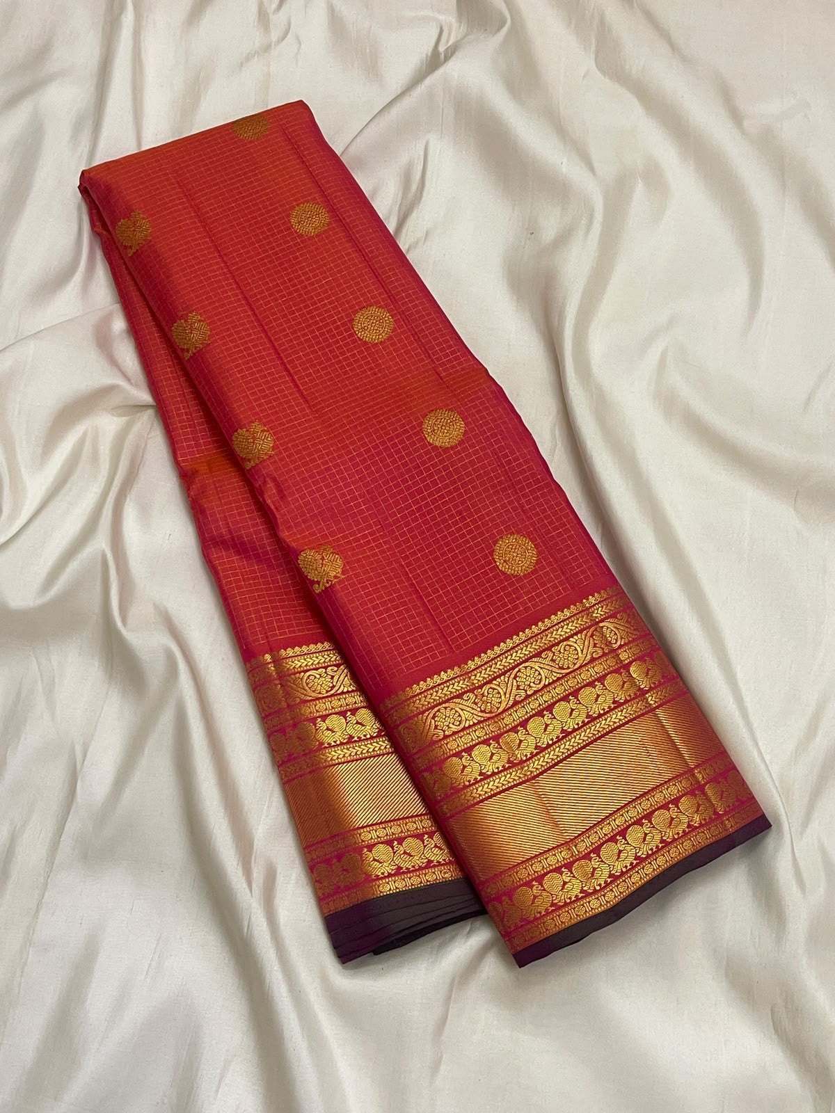 Double-shot coral and sunset orange Pure Silk Kanchipuram Zari Kattam saree with Varisaipet border, Rudraksham detail, and grand pallu.