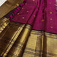 Close view of small gold buttas spaced across the vadamalli pink and antique gold silk