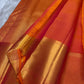 Sunset orange vermillion Kancheepuram saree, vermilion zari border with floral vines close-up