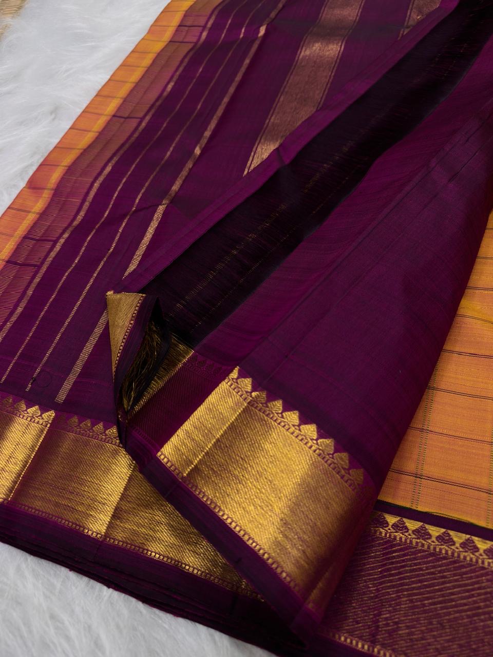Kanjeevaram pure silk saree in sunset orange double shade with richly woven purple pallu