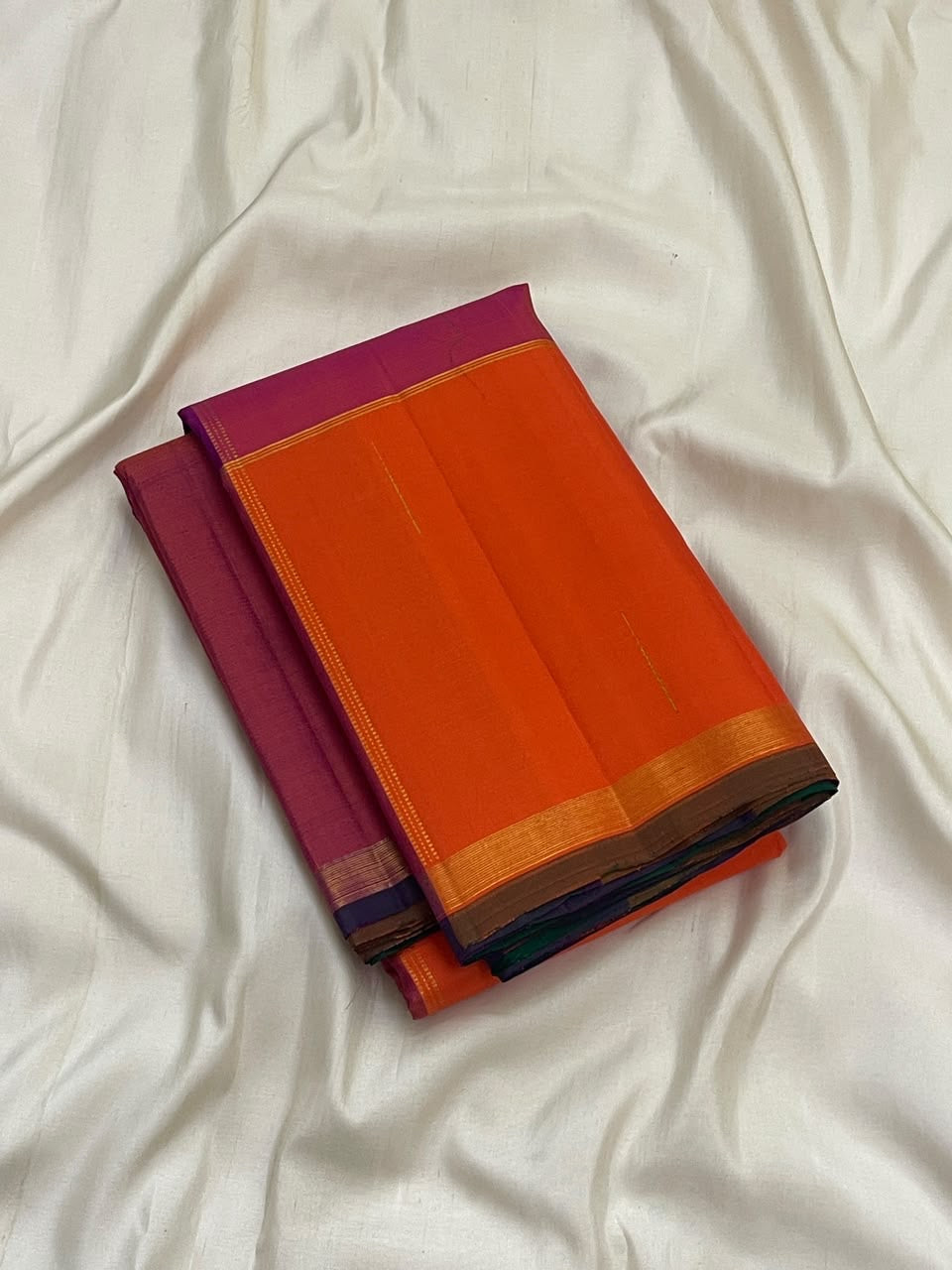 Sunset orange and pink Kancheepuram silk saree with forest green pallu