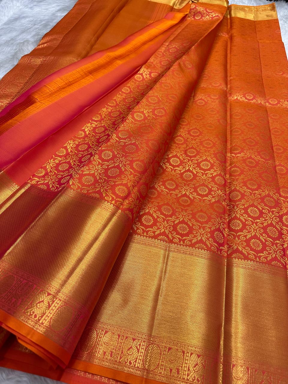 Sunset orange vermillion Kancheepuram saree, vermilion orange border with floral vine motifs detail