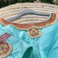 Front view of pastel green silk Tanjore Treasure blouse featuring jewelry-inspired embroidery
