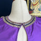 Purple silk Tanjore Treasure blouse with gold embroidery displayed on a hanger