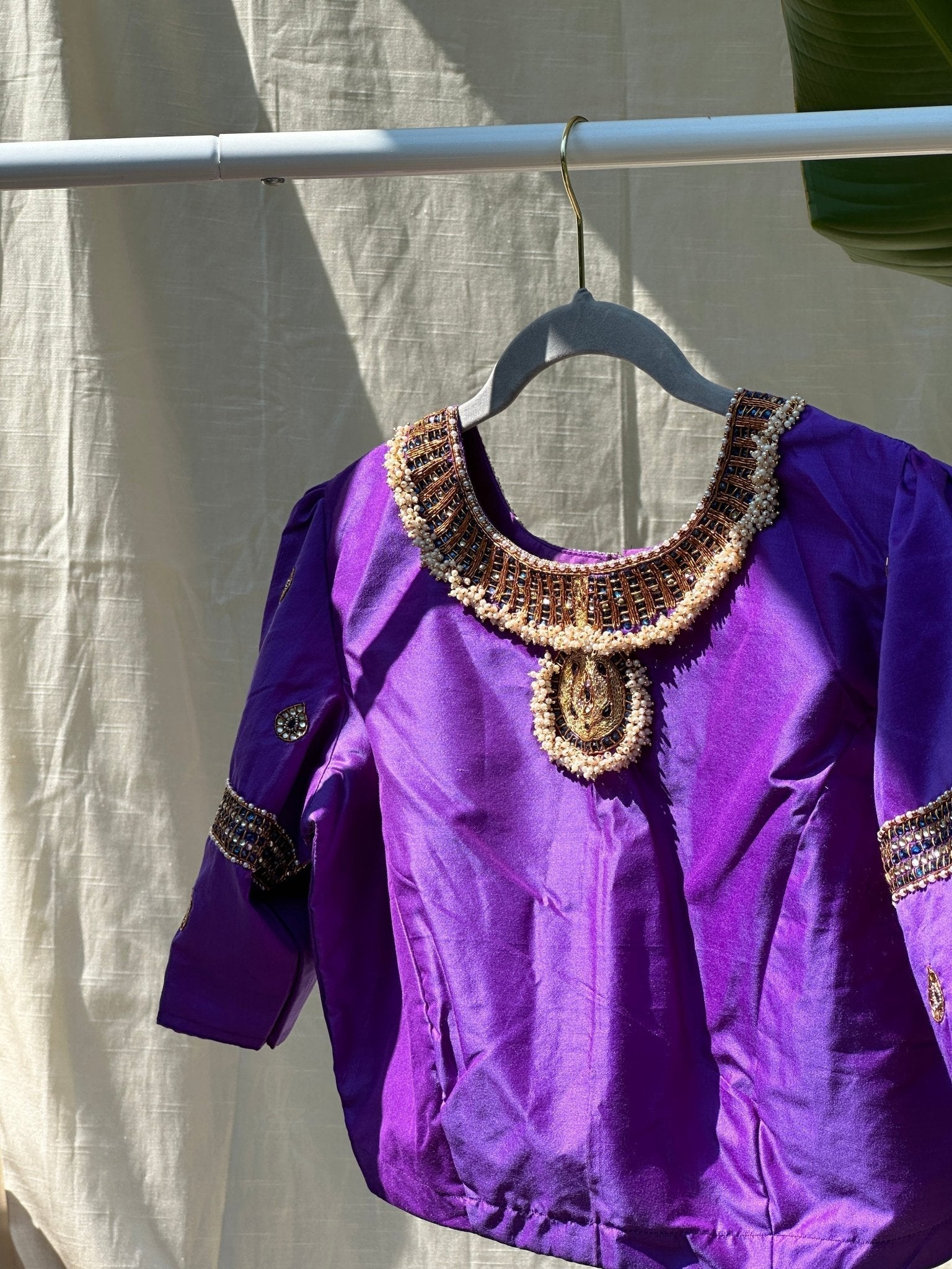 Side angle of purple silk Tanjore Treasure designer blouse with intricate embellishment