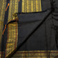 Black pallu with dense vertical gold-zari panels and tanpura woven silk-thread buttas.
