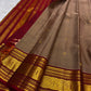 Contrast ruby red pallu on a chandanam (sandalwood) Pure Silk Kanjivaram saree