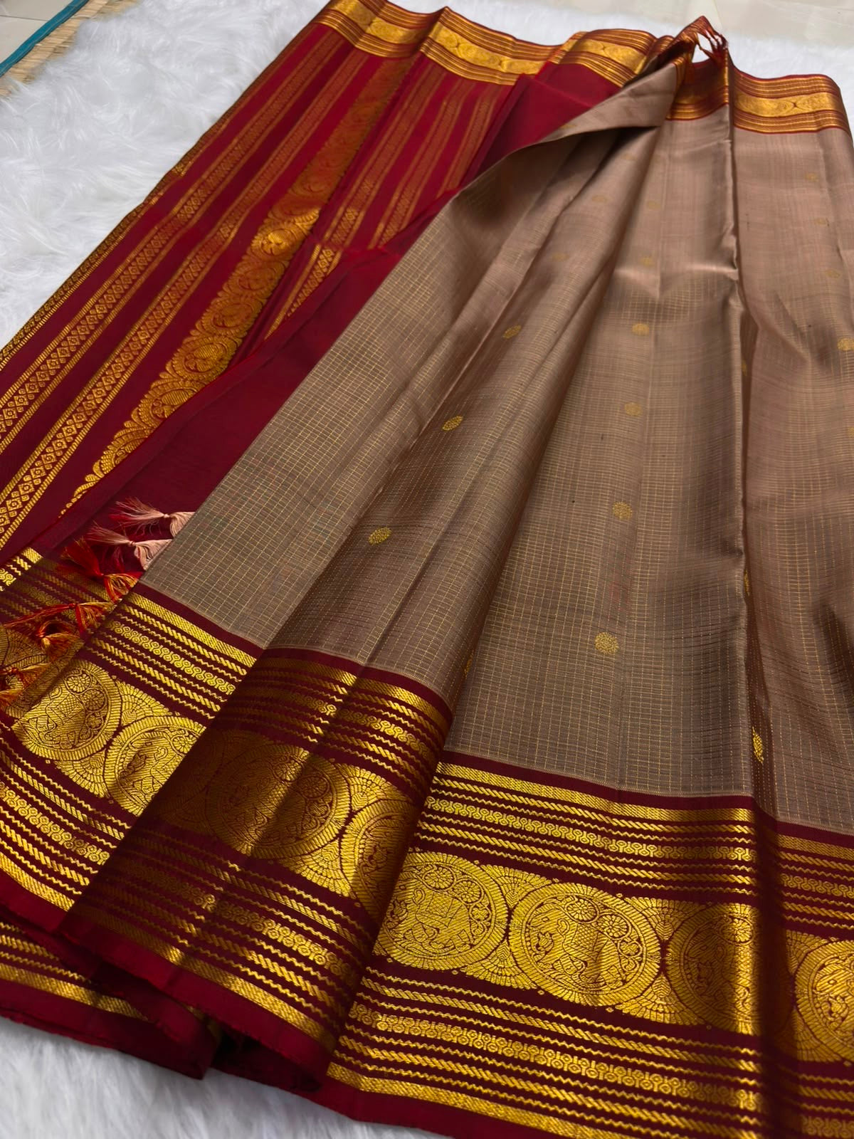 Contrast ruby red pallu on a chandanam (sandalwood) Pure Silk Kanjivaram saree