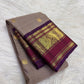 Taupe Brown Kanchipuram silk body with spaced gold zari buttas and richly woven purple Varisaipet border.