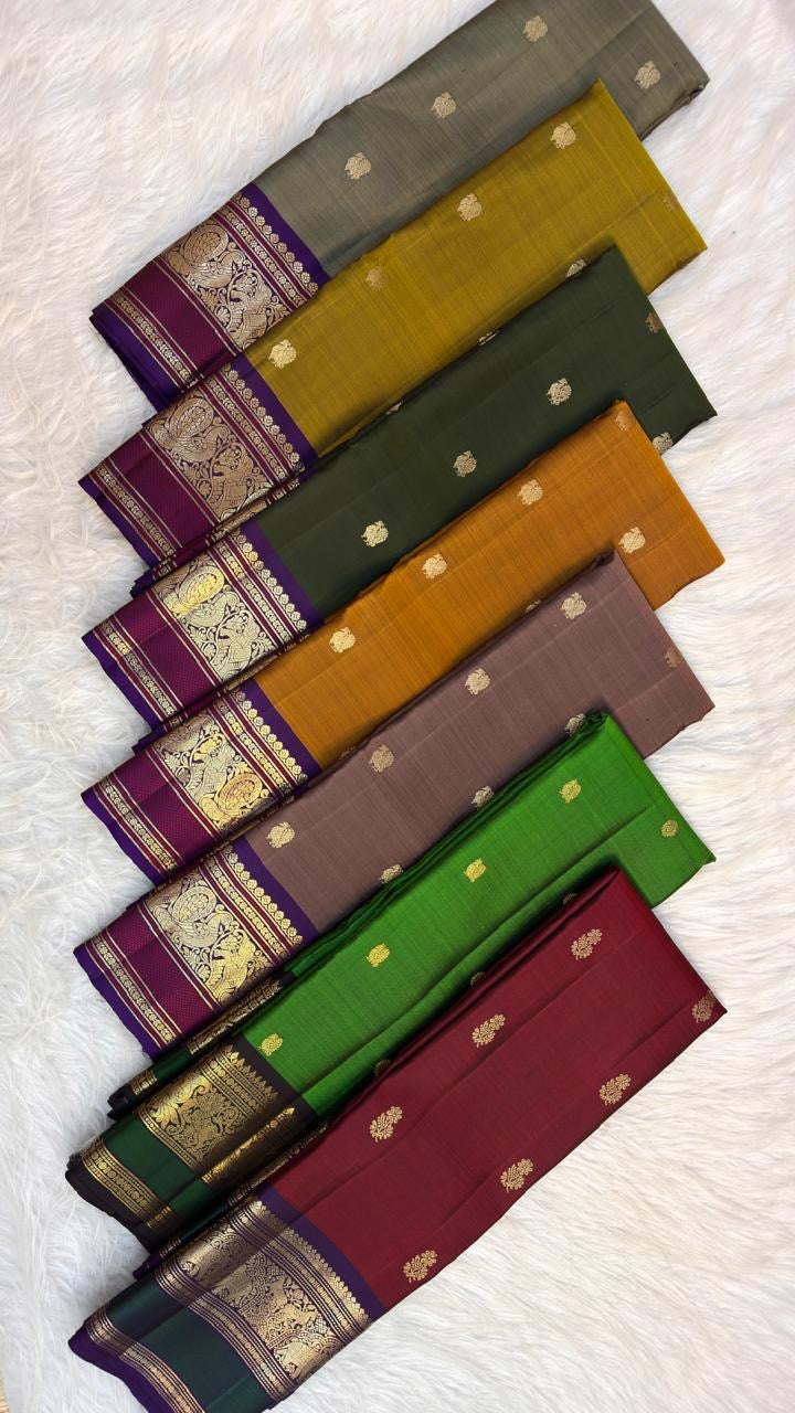 Kathiripoo purple Kanchipuram border with Mayil motifs and gold-zari detailing against the taupe body.
