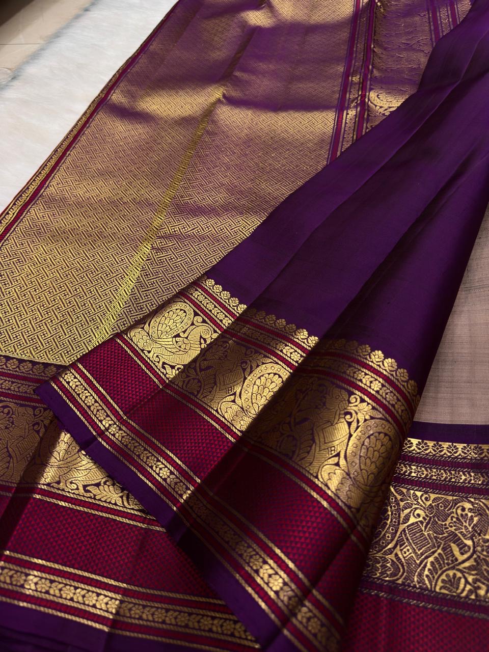 Smoky brown pure mulberry silk saree with small spaced zari motifs and traditional purple gold border.