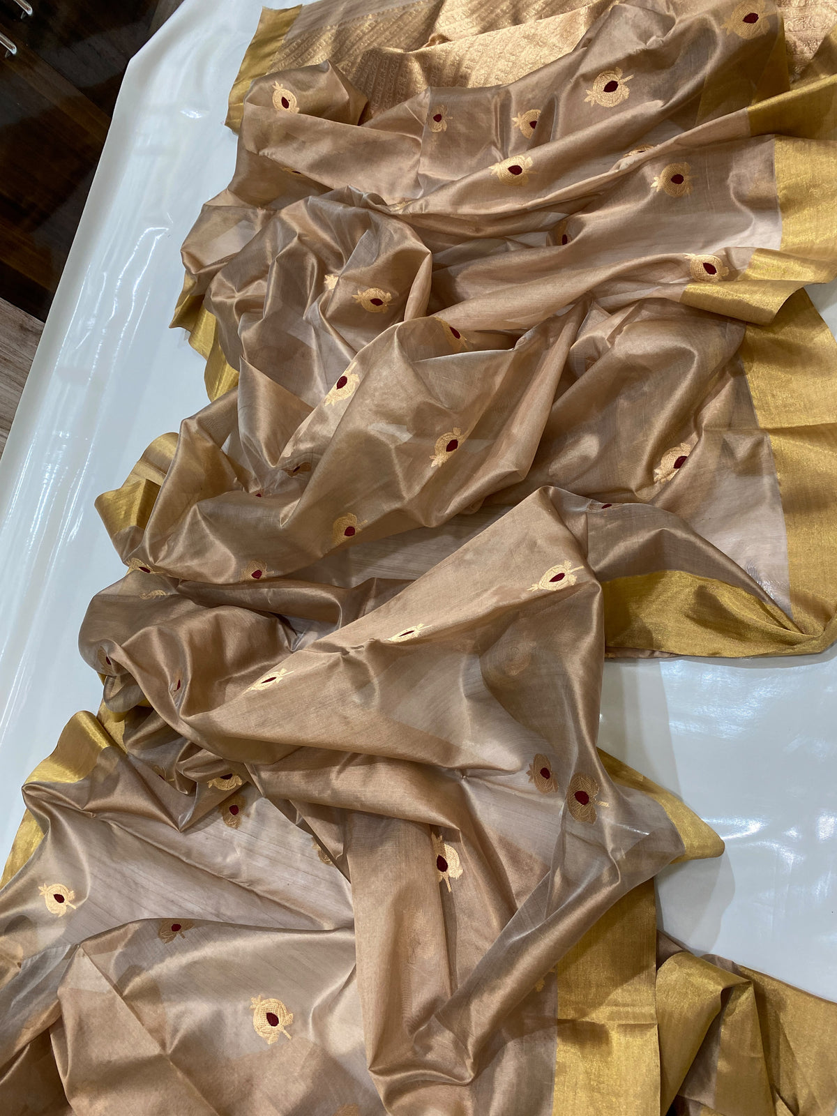 Taupe Chanderi saree with gold-toned and red motif details