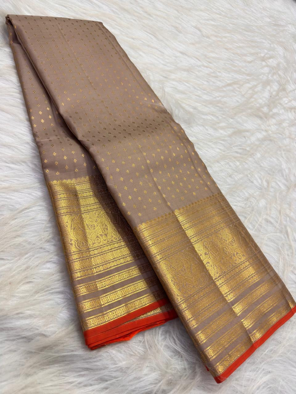 Close view of antique-gold geometric zari weaving on Smoky Taupe Kanchipuram silk.