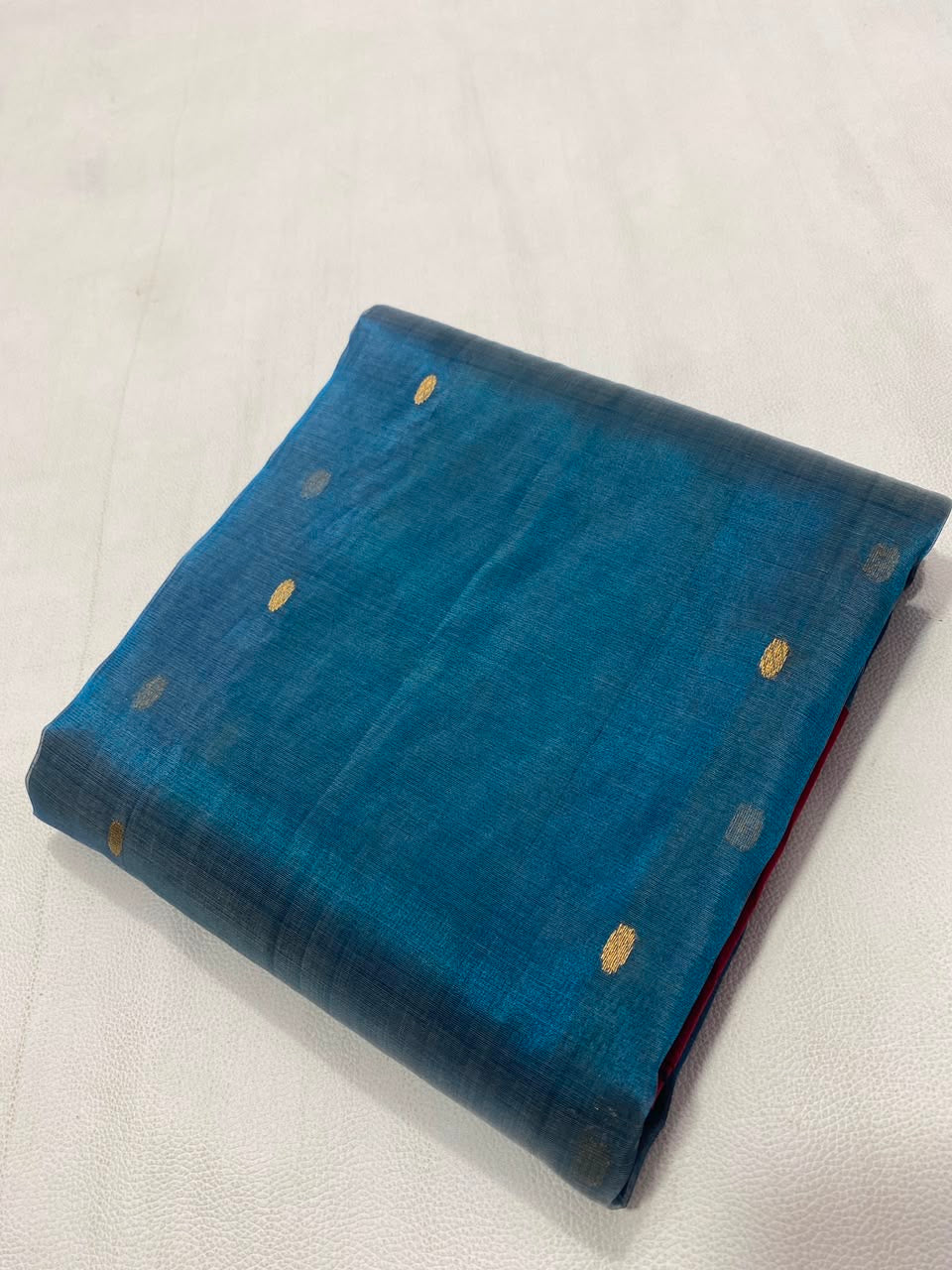 Teal Blue Tissue Silk Chanderi saree showing the broad Raspberry Pink contrast border with gold accents.