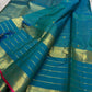 Teal-blue Zari Kattam body with individually spaced classic-gold zari buttas across the checked field.