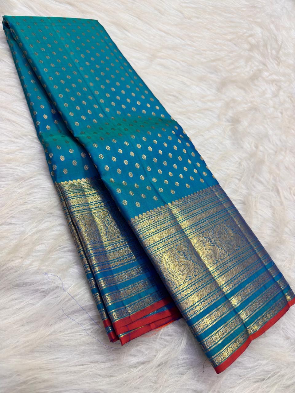 Sapphire Blue and antique-gold Kanchi Pattu saree with fine Red selvedge detail.