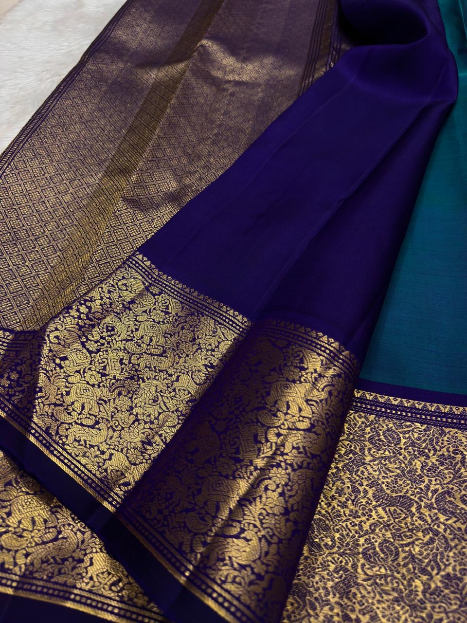 Deep purple vanasringaram border with gold zari forest motifs on teal shot colour Kanchipuram saree — Idam Living
