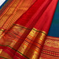 Close-up of shot colour peacock blue-green with blue dominance silk body with gold zari Mayil Chakram circular butta motifs