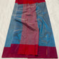 Teal Blue handloom Chanderi saree showing metallic buttas and broad Raspberry Pink contrast border with gold accents.