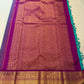 Detailed view of teal and gold zari border against the vivid magenta-pink Vairaoosi silk body