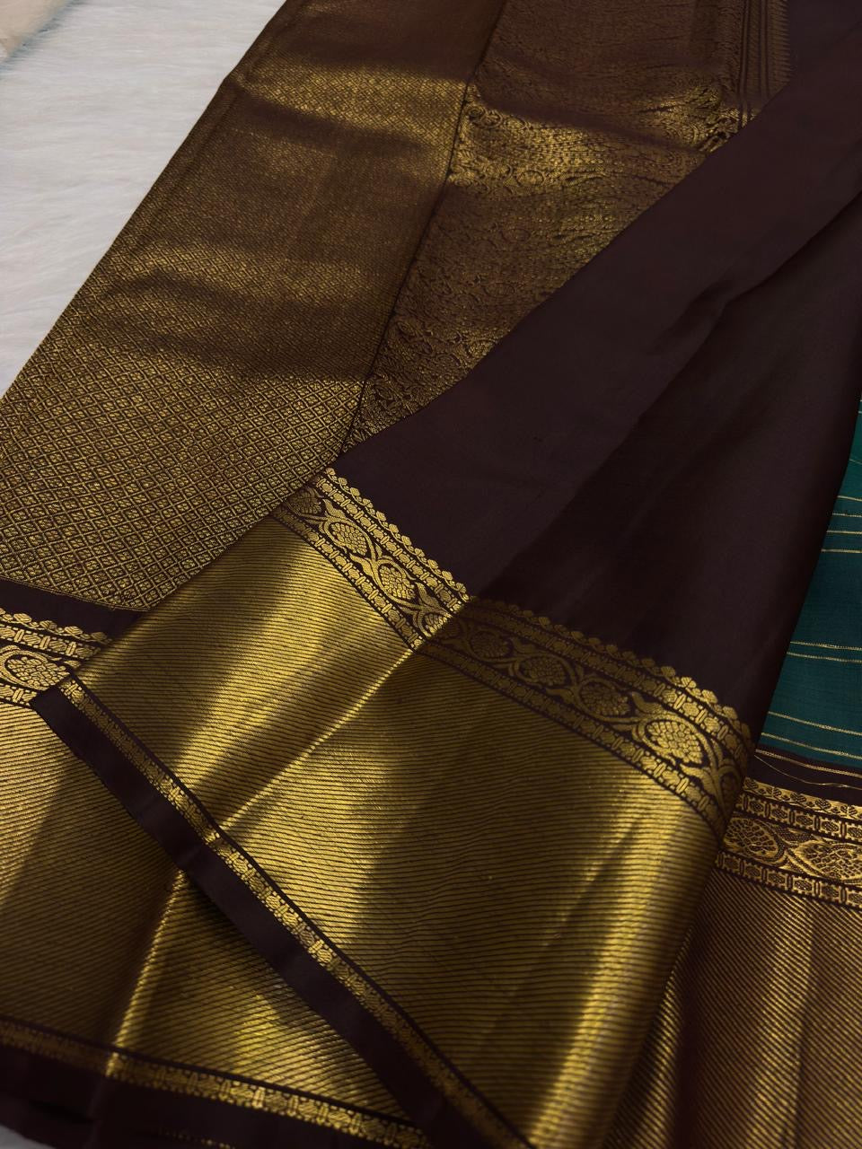 Deep teal Kanchipuram silk with chocolate brown and gold zari border