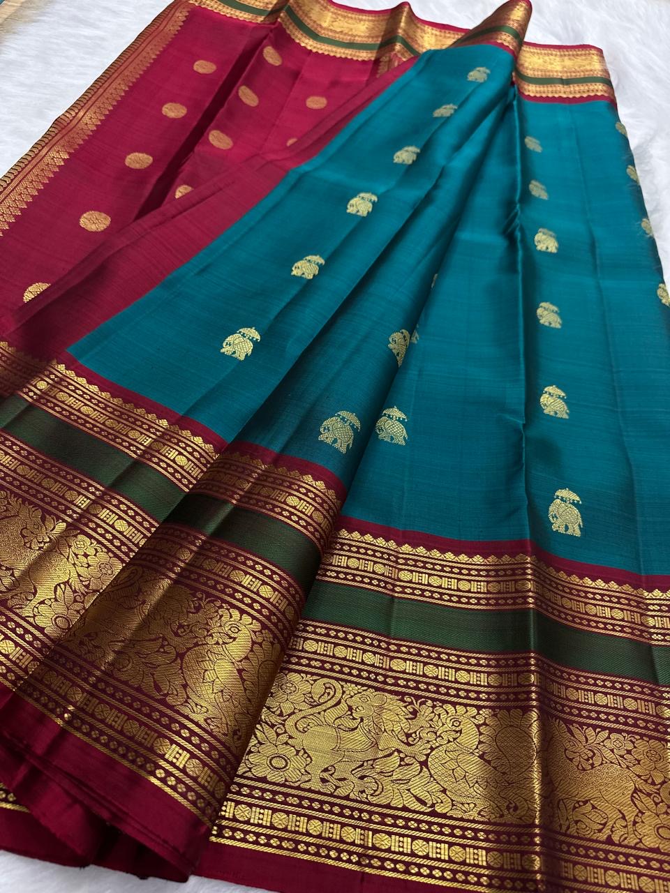 Close view of teal green Kanchipuram silk body with ornate gold zari Yaanai Ambari elephant procession Butta