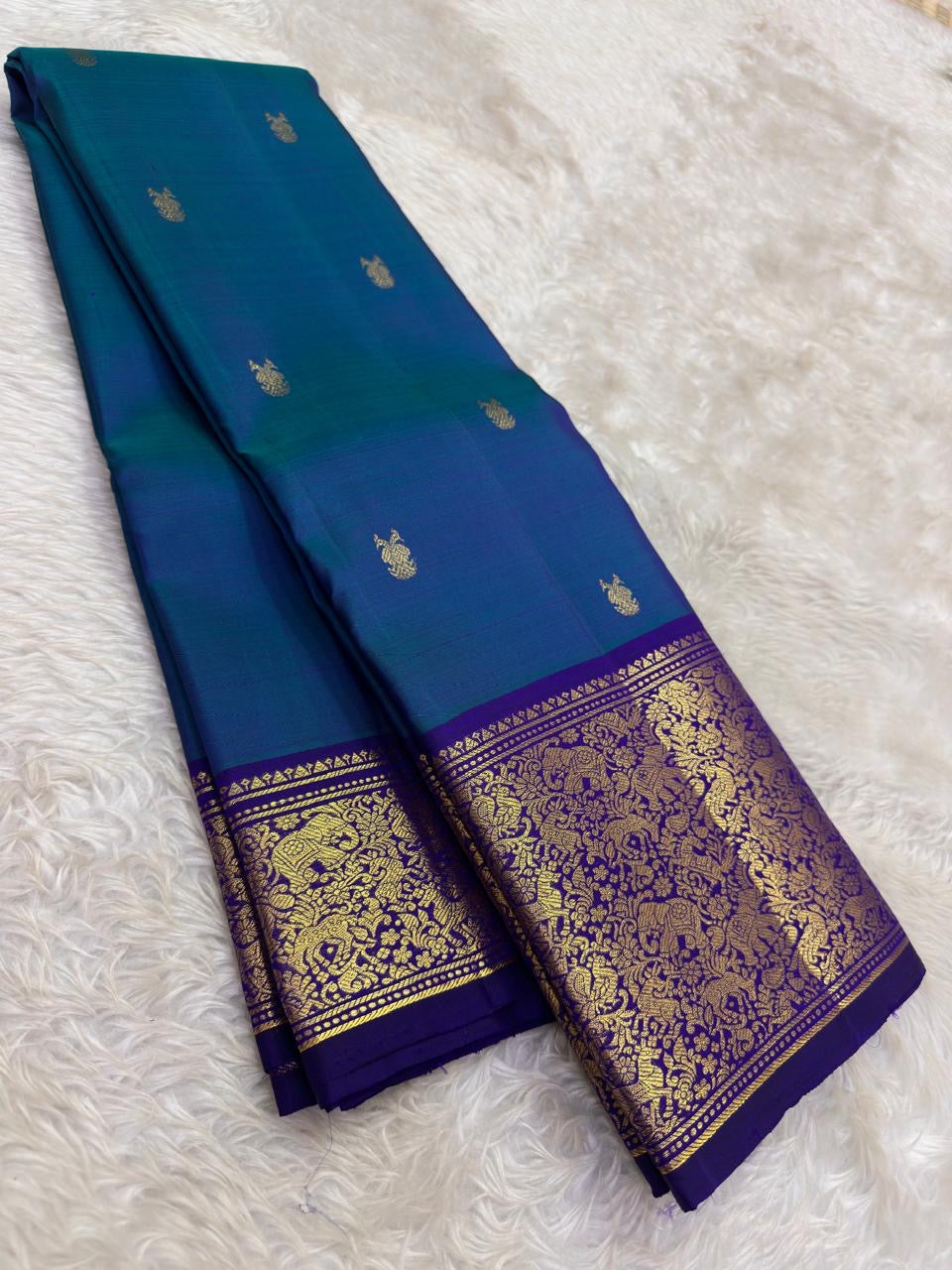 Close-up of gandaberunda double-headed bird butta in gold zari on teal Kanjeevaram silk saree — Idam Living