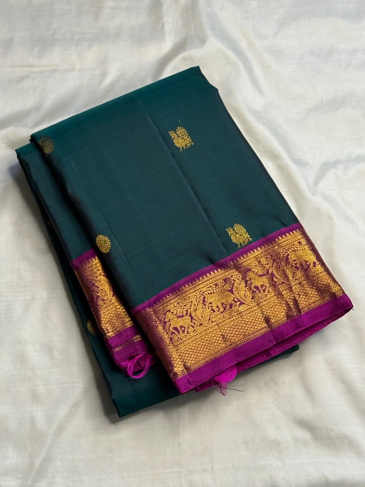 Spaced antique-gold-toned buttas across Deep Teal silk.