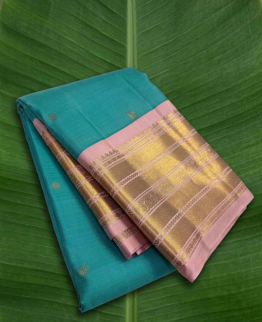 Kanchipuram silk saree in lagoon blue with blush pink border Korvai weave folded view