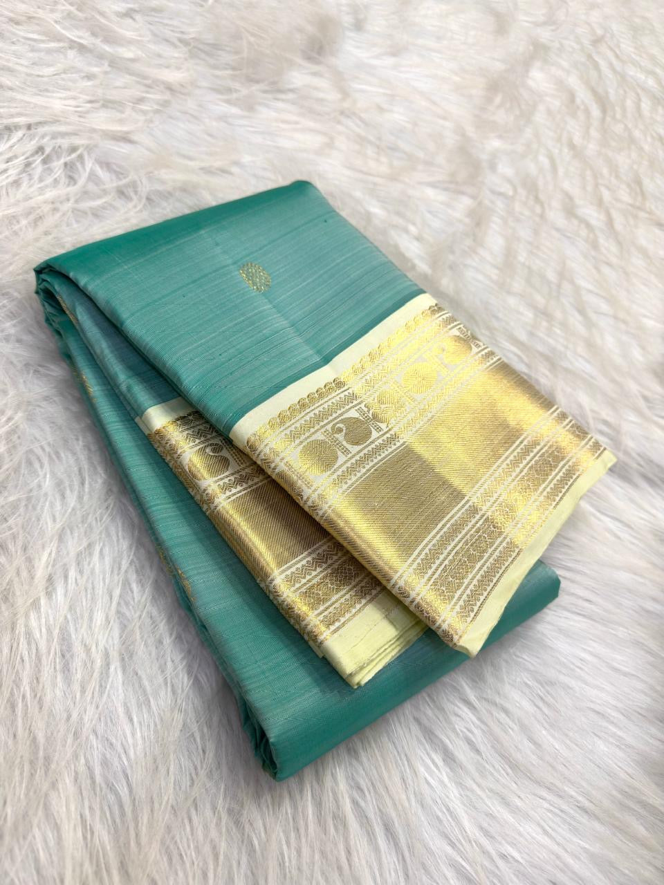 Aqua Teal Pure Silk saree with scattered gold zari buttas and Warm Ivory Korvai border