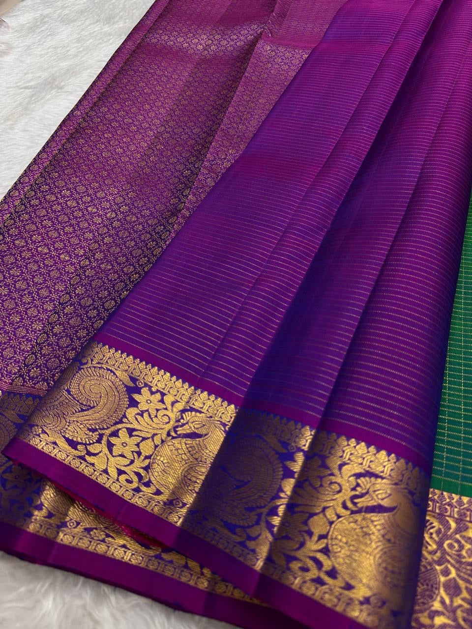 Large mayil peacock gold zari border close-up on teal shot colour Kanjipuram saree — Idam Living