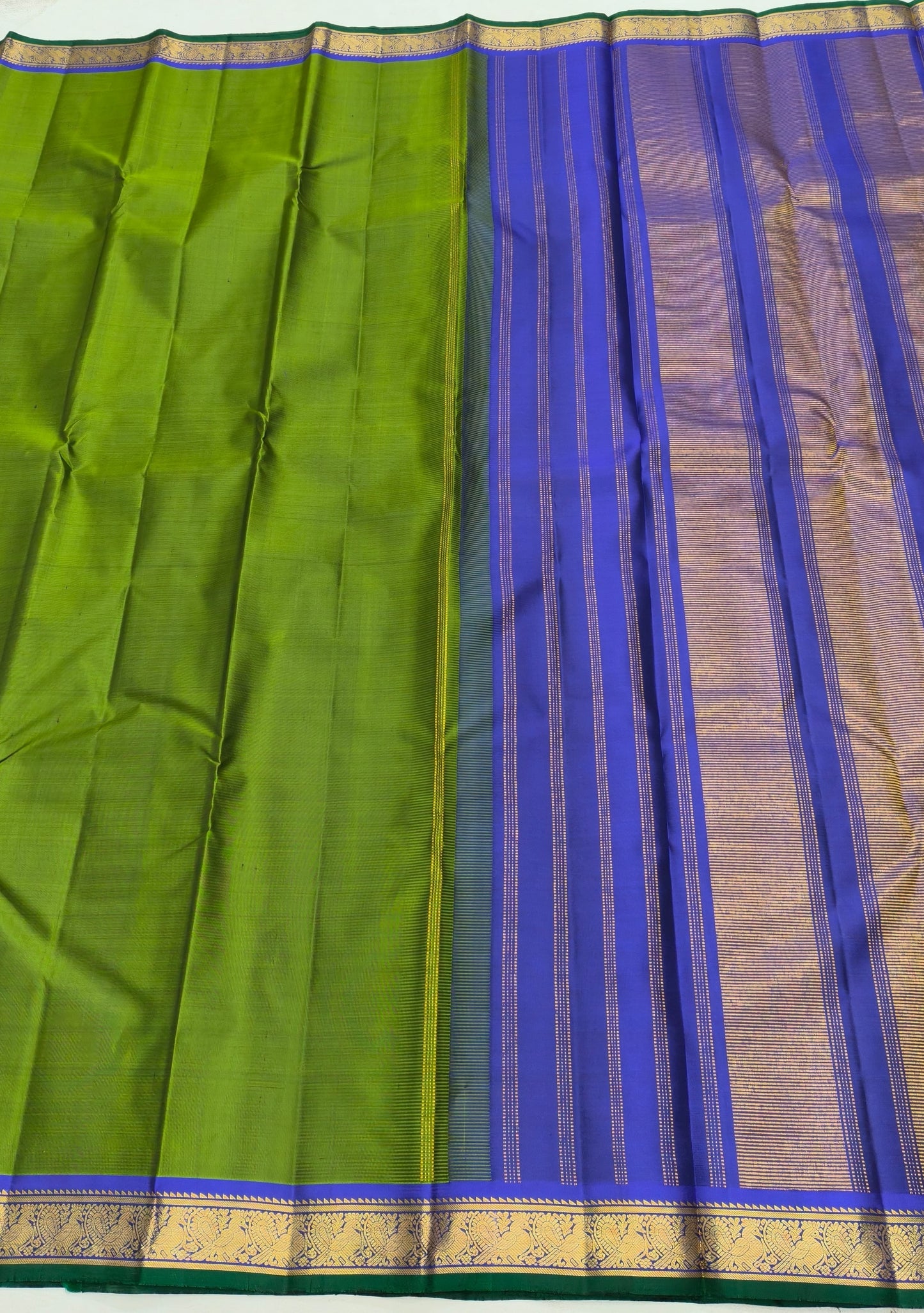 Temple olive green Kanjivaram saree with traditional zari yaanai border – full drape view