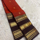 Maanga-inspired gold zari ornament on the Kaapi Kottai brown Varisaipet border of the Terracotta Orange-Red Kanchipuram saree