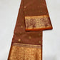 Terracotta Chanderi saree with an intricate gold floral border framed in deep maroon