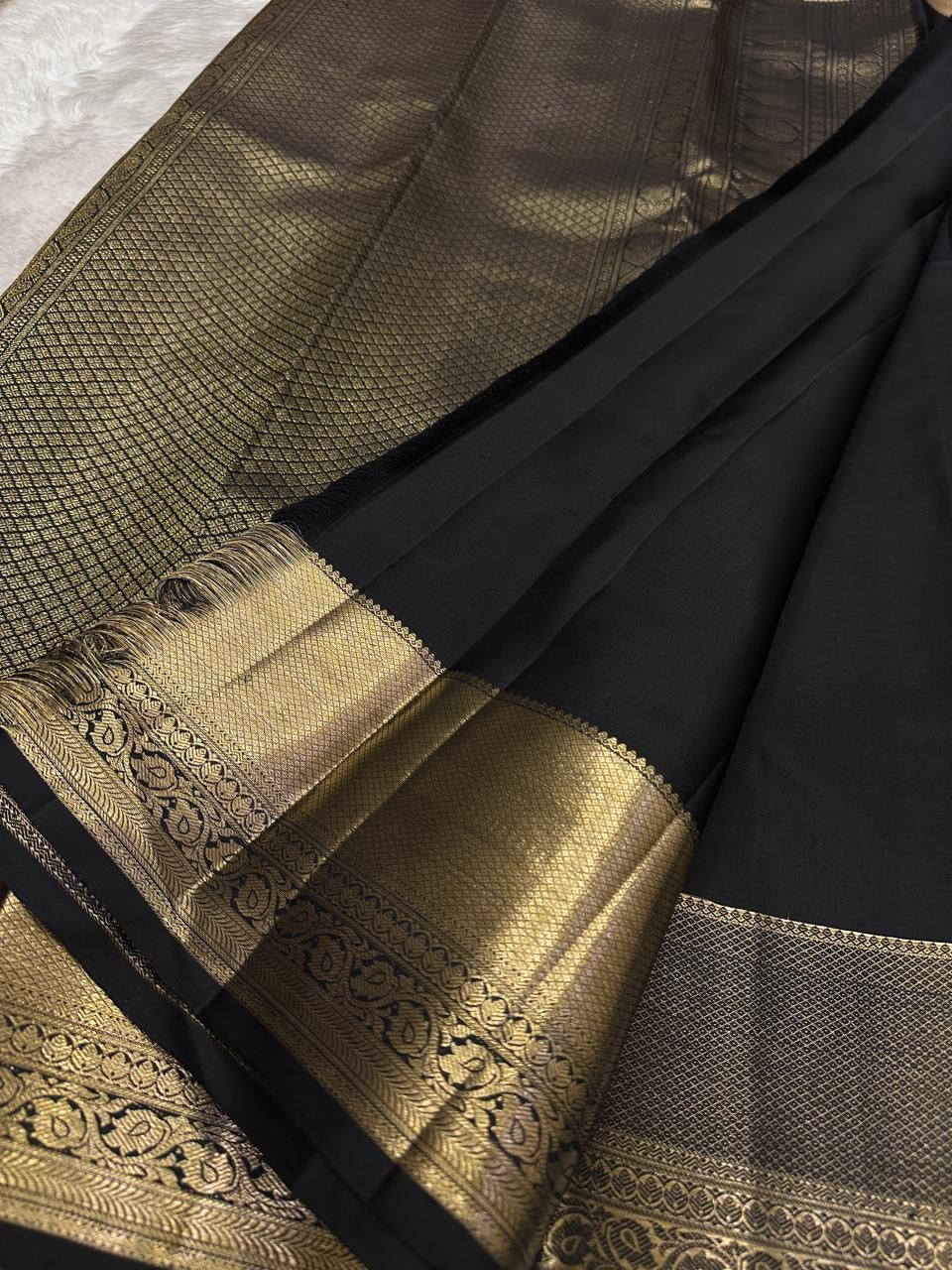 Jet Black Kanjivaram showing large Thazhampoo Reku buttas across the silk body.