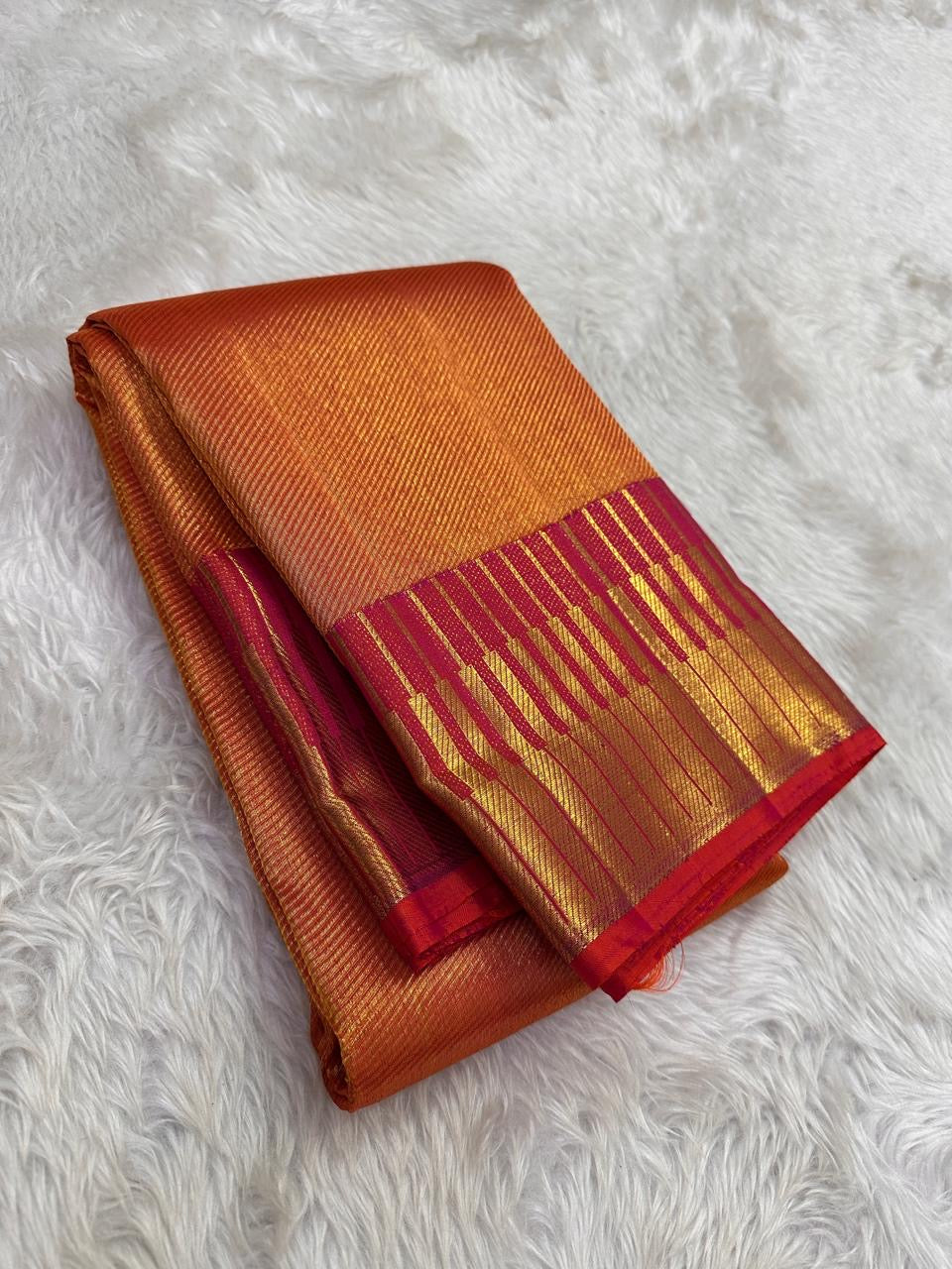 Very thick orange pure silk saree showing a luminous grid and expansive magenta border